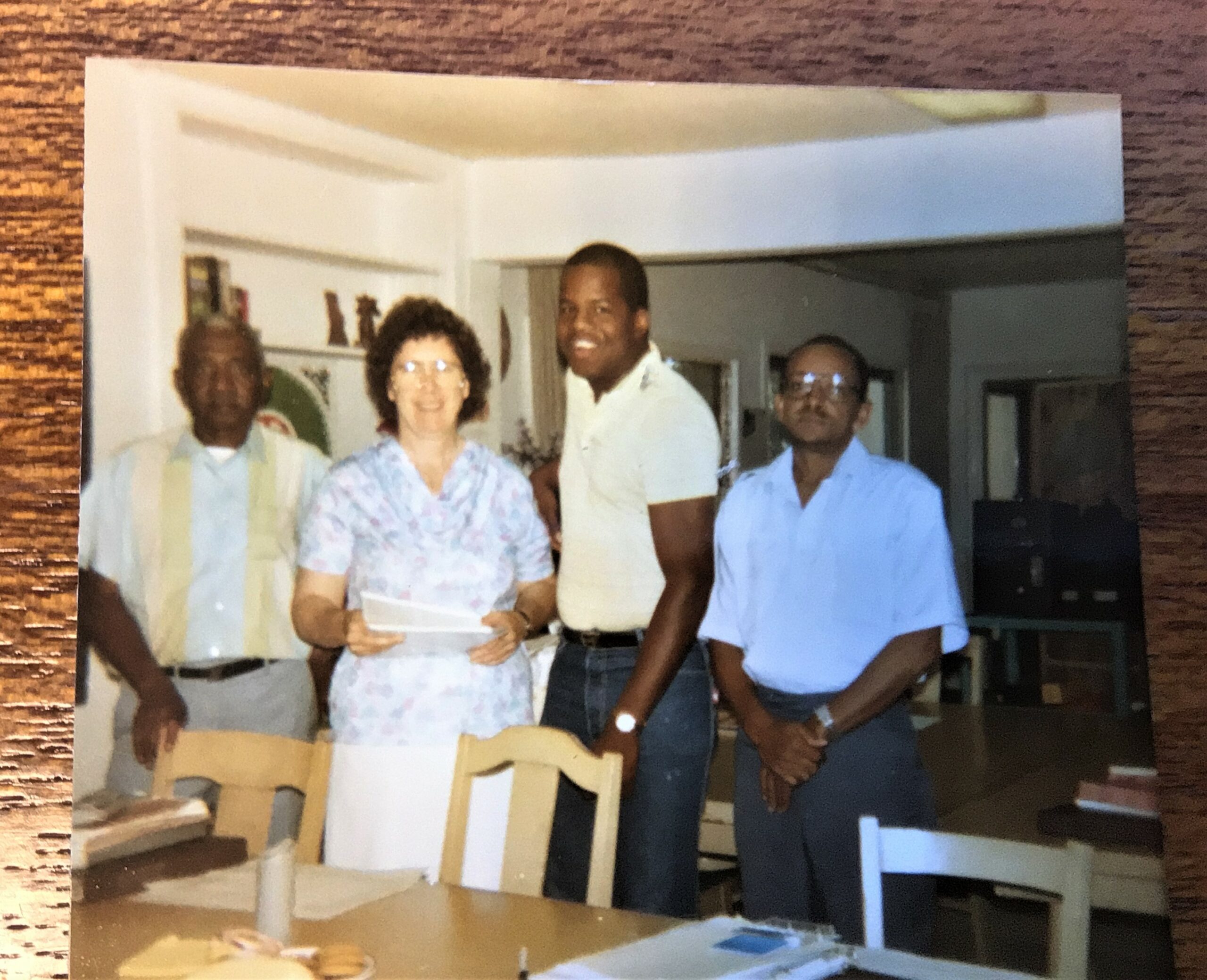 A smiling group of a sister and three Black men.