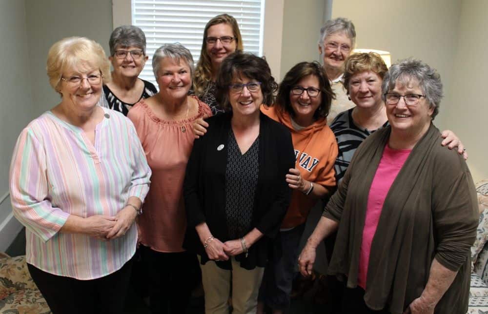 Nine women in a group photo