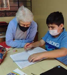 Sister Doreen Glynn working with a student