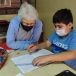 Sister Doreen Glynn working with a student in Peru