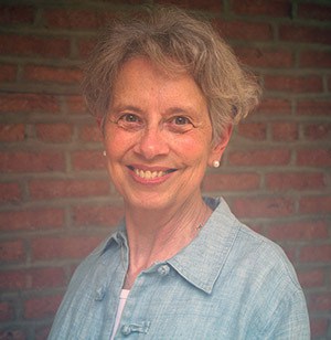 Barbara Jennings, CSJ stands in front of a brick wall