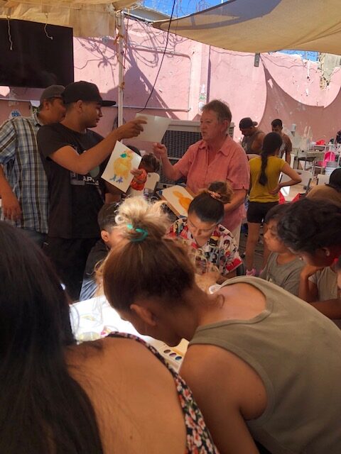 A group of families painting 