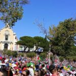 World Youth Day 2023 Pilgrims standing in a massive crowd.