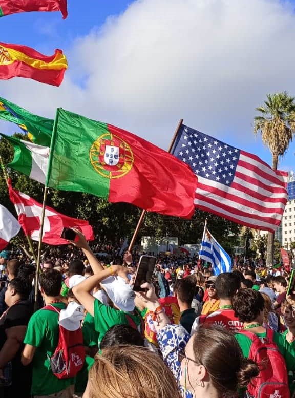 World Youth Day pilgrims holding up the Portuguese and American flags.