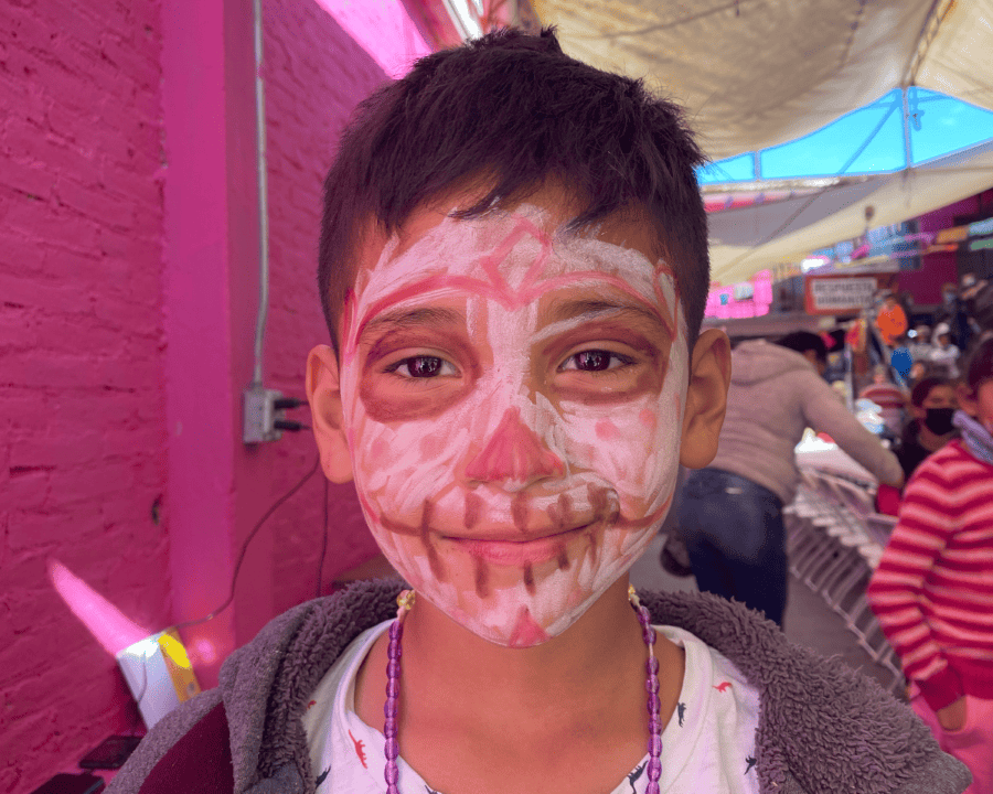 Child with skull face paint for Día de los Muertos