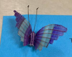 A purple butterfly pin made from dyed horsehair