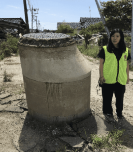 Noto Peninsula Earthquake Volunteer standing next to a manhole at eye level