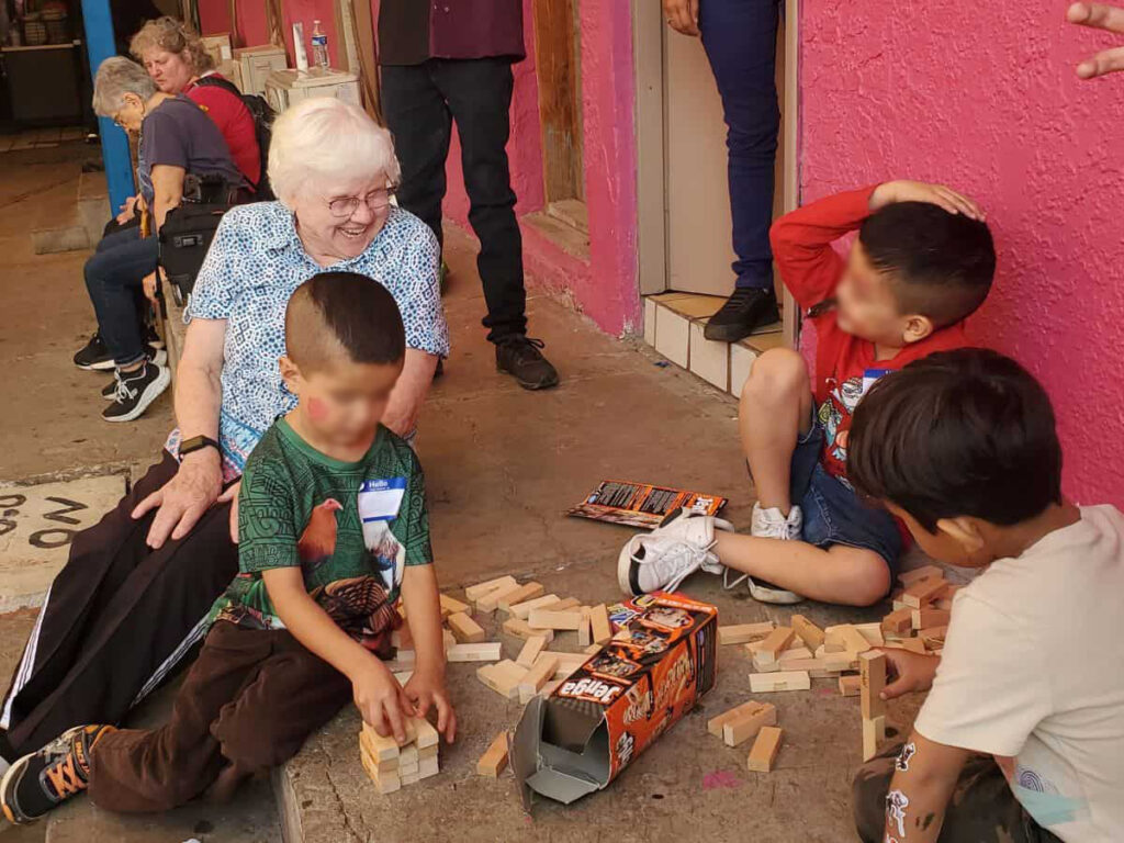 Barbara Anne Stowaser playing jenga with three kids