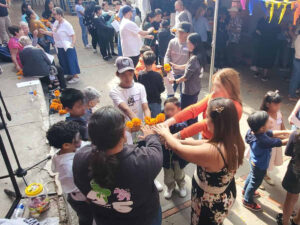 Blessing carnations for Dia de los Muertos