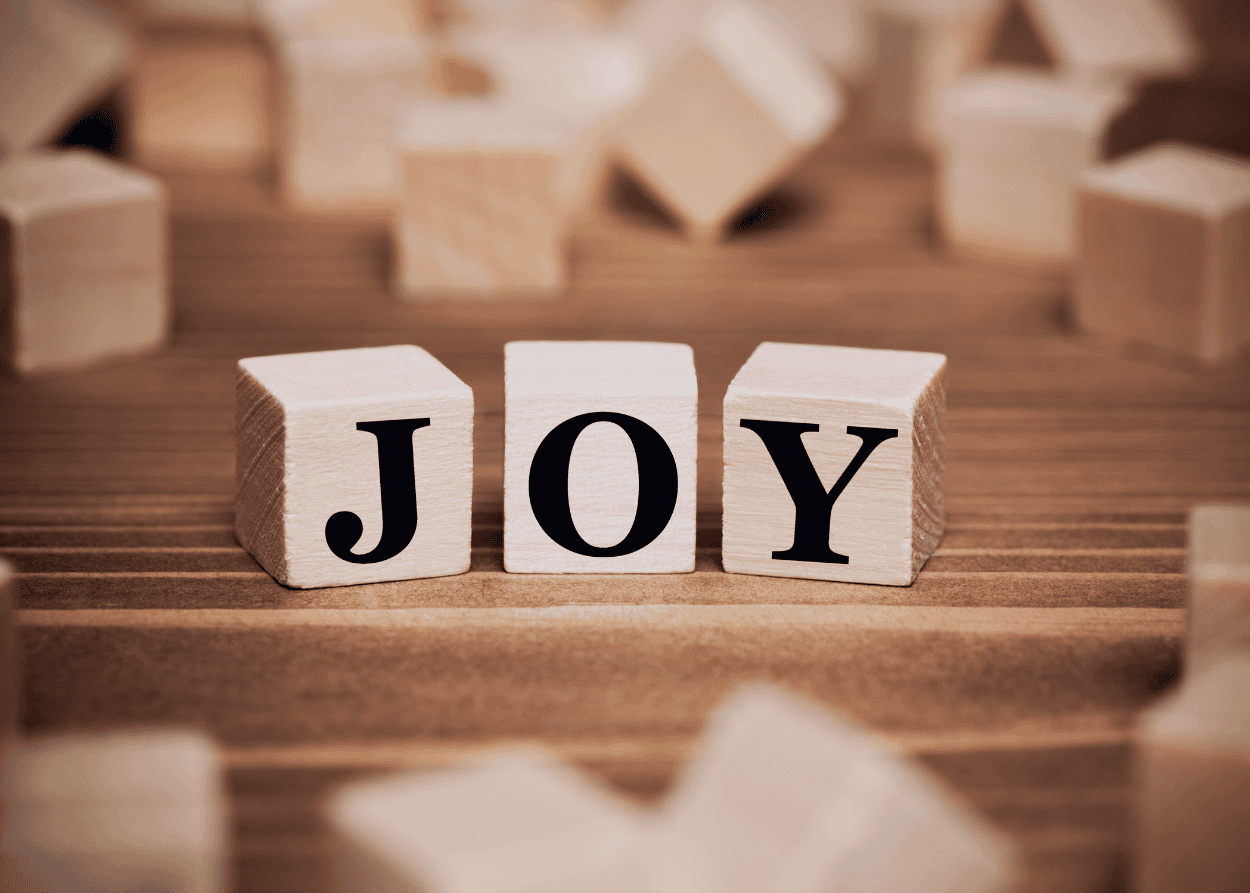 Wooden blocks with "Joy" written across three of them