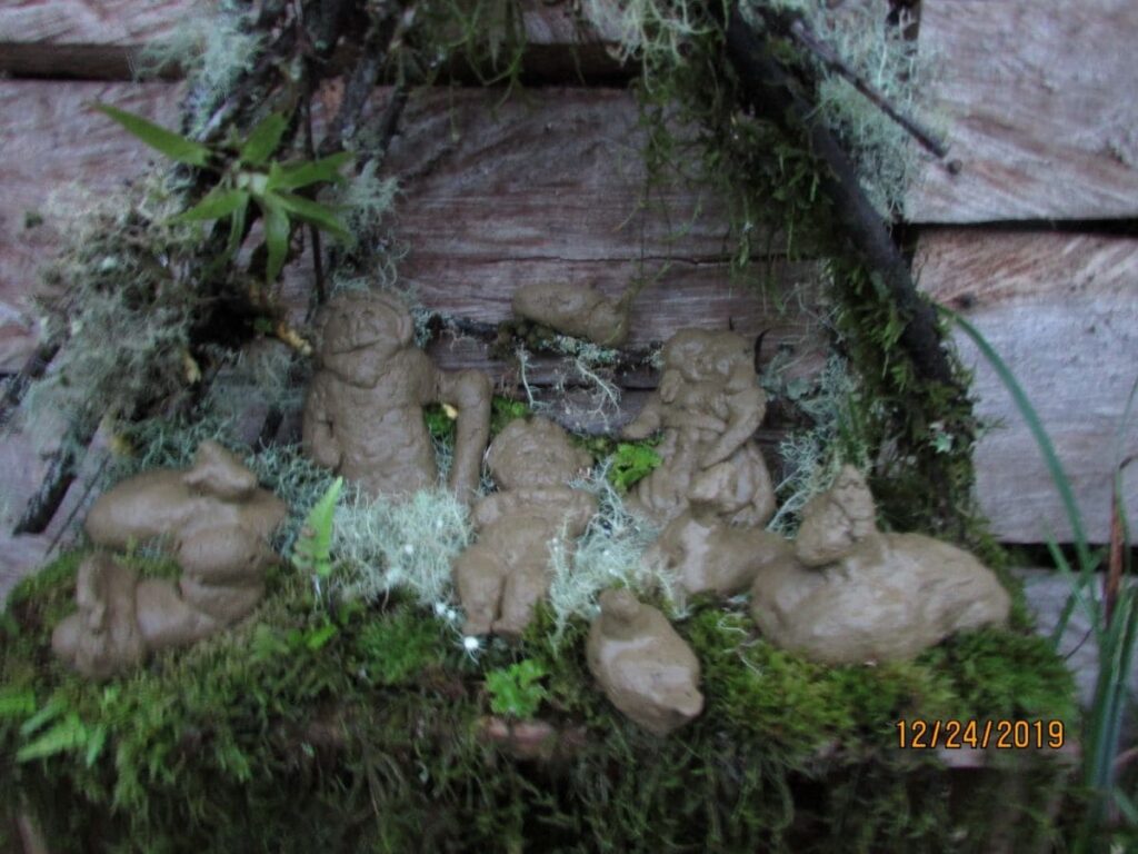 A nativity scene made from clay and plants