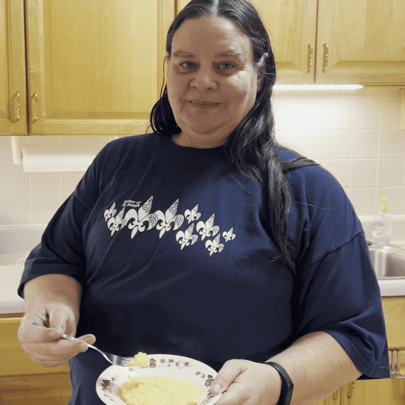 Sister Sandy Schmid holding a plate of her homemade risotto