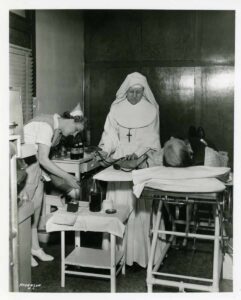 A nursing Sister takes a blood donation from a patient. St. Joseph’s Hospital, Hancock, MI, 1959