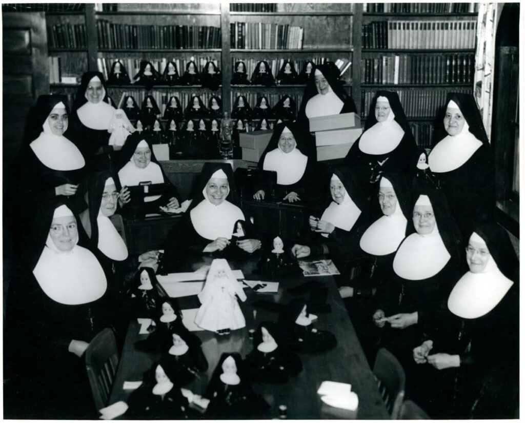 Fourteen sisters in habits creating little nun dolls