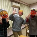 Three sisters wearing ogre masks for the Lunar New Year