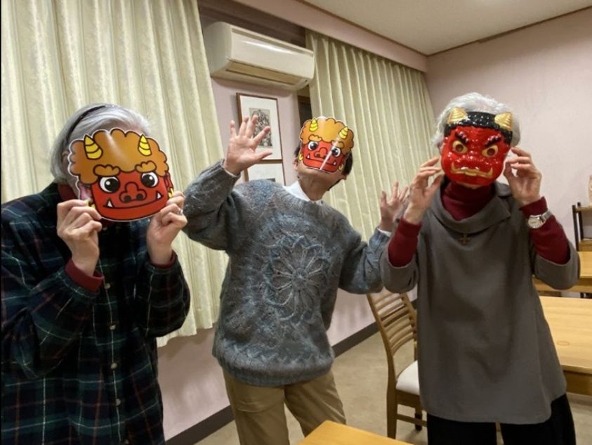 Three sisters wearing ogre masks for the Lunar New Year