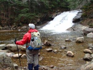 Sister Linda Neil hiking by a stream