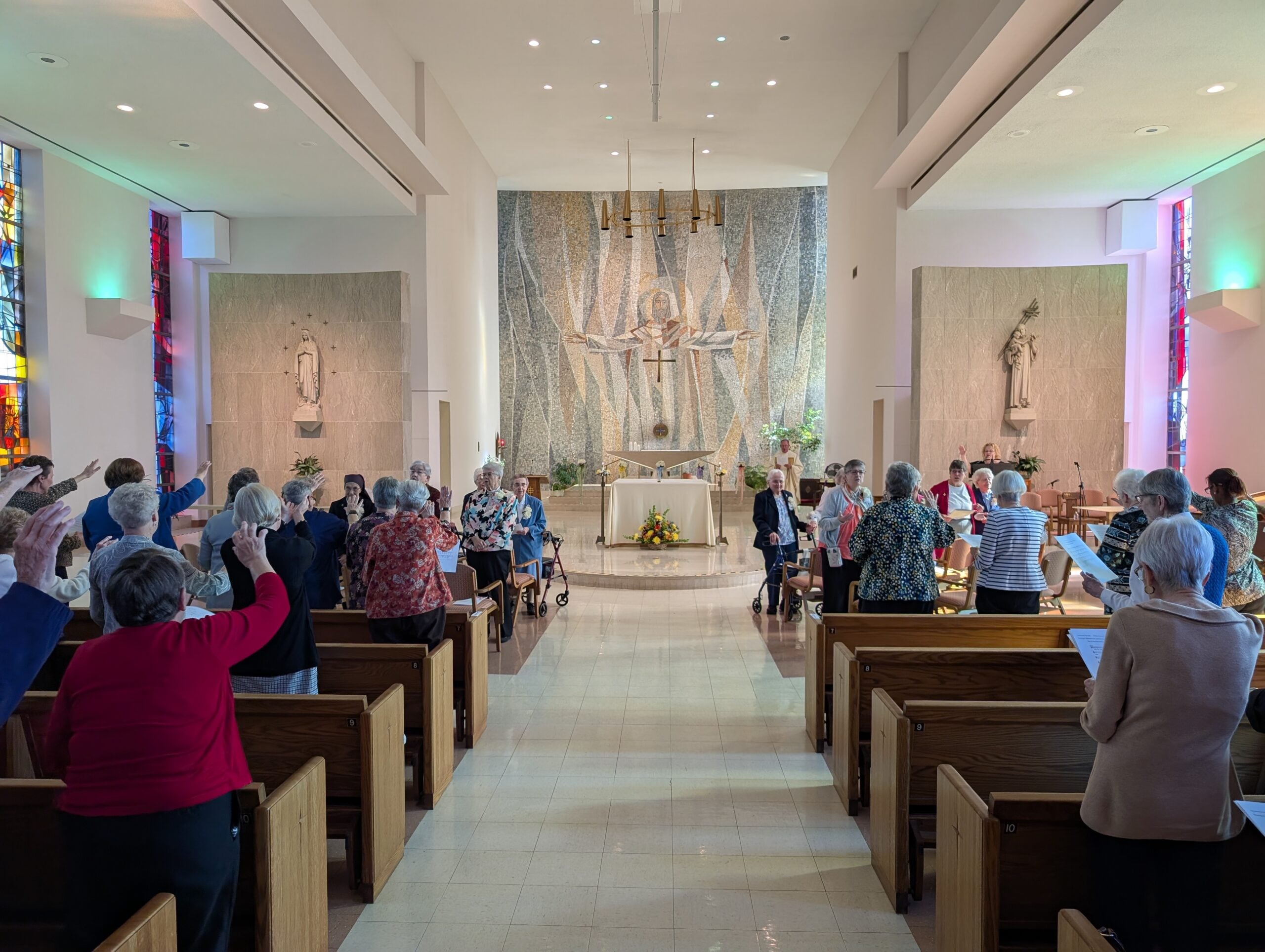 CSJ Sisters in Albany, NY with their arms extended during a prayer service
