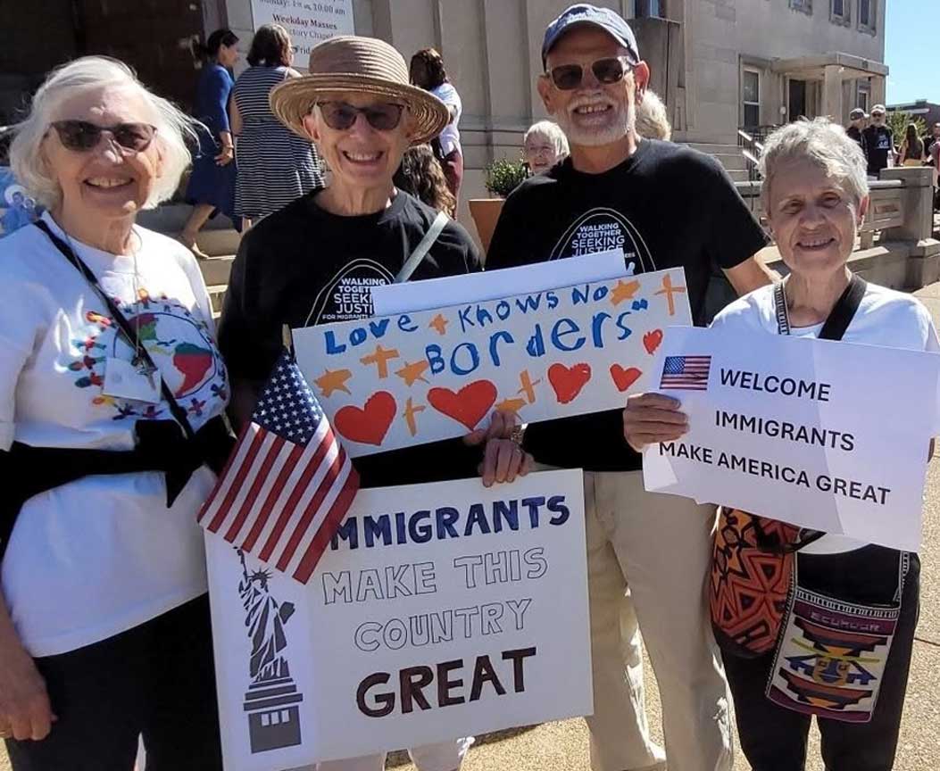 CSJ Sisters and Associates holding signs supporting Immigrants