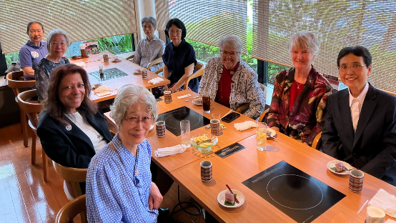 Sisters seated a table for a Japanese meal